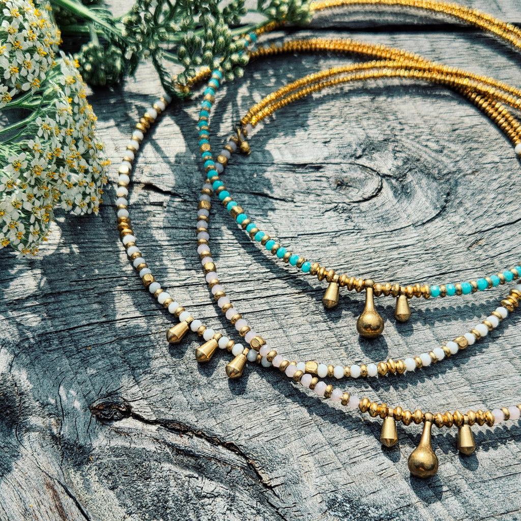 Necklaces with beads on a wooden surface